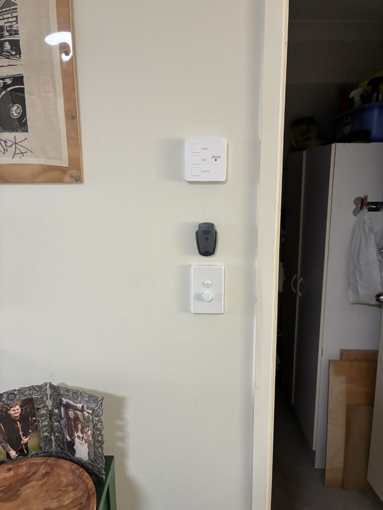 Watch brand wall-mounted smoke alarm controller with HUSH TEST and LOCATE buttons in a Brisbane home