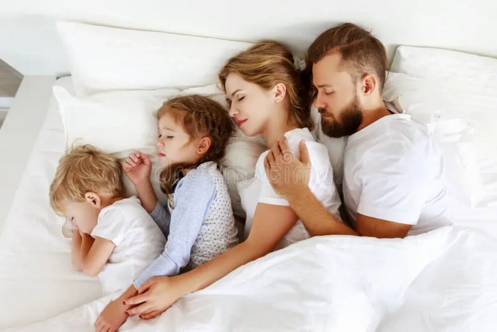 Family sleeping safely in Brisbane home protected by compliant smoke alarms